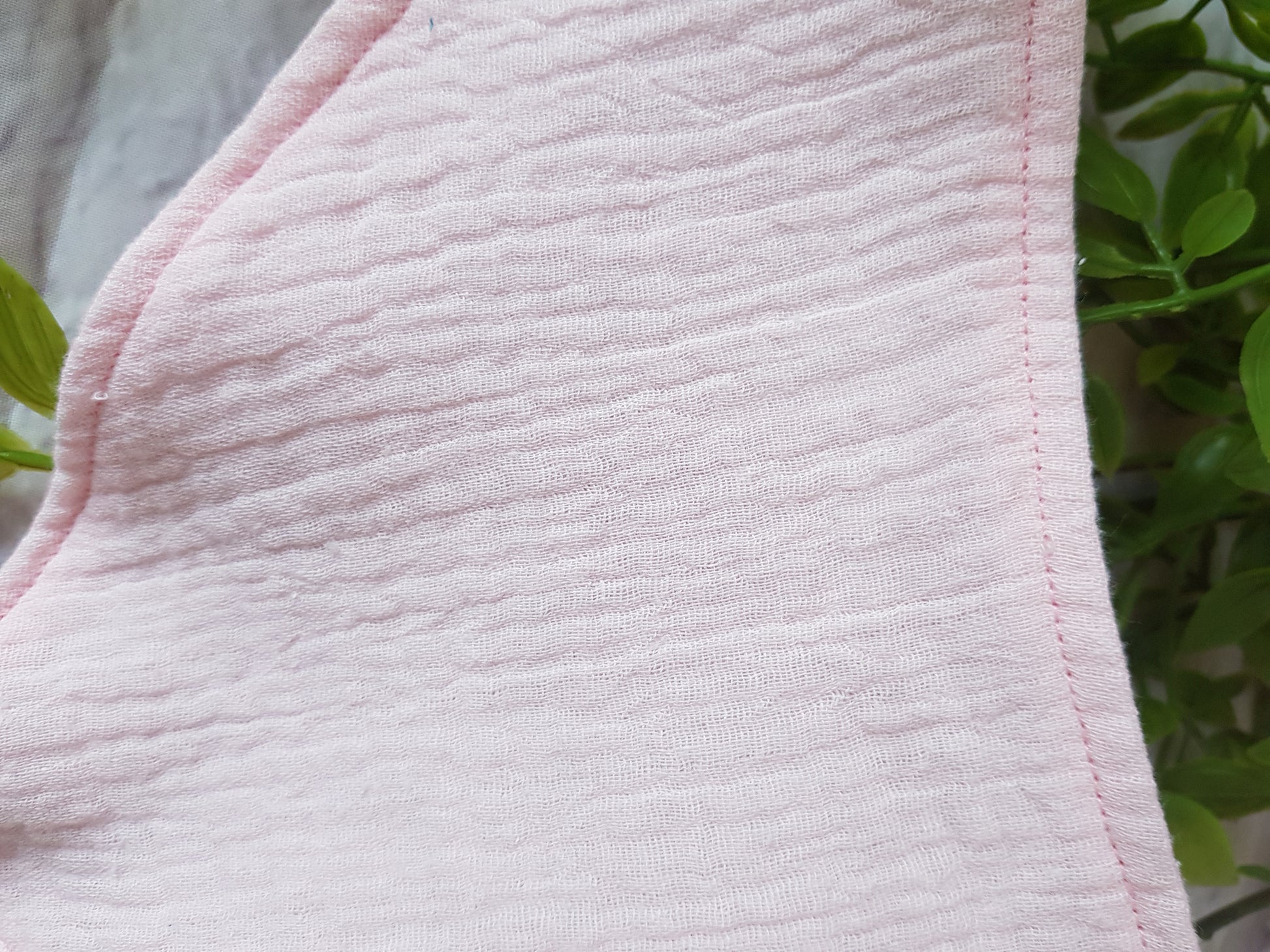 Detailansicht des Babyhalstuchs aus Musselin in rosa